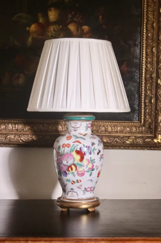 Chinese style painted clay table lamp on gilt base pleated shade.