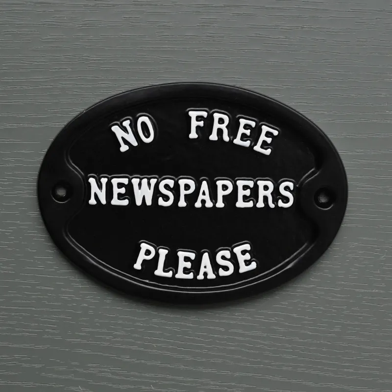 No Included Newspapers Sign